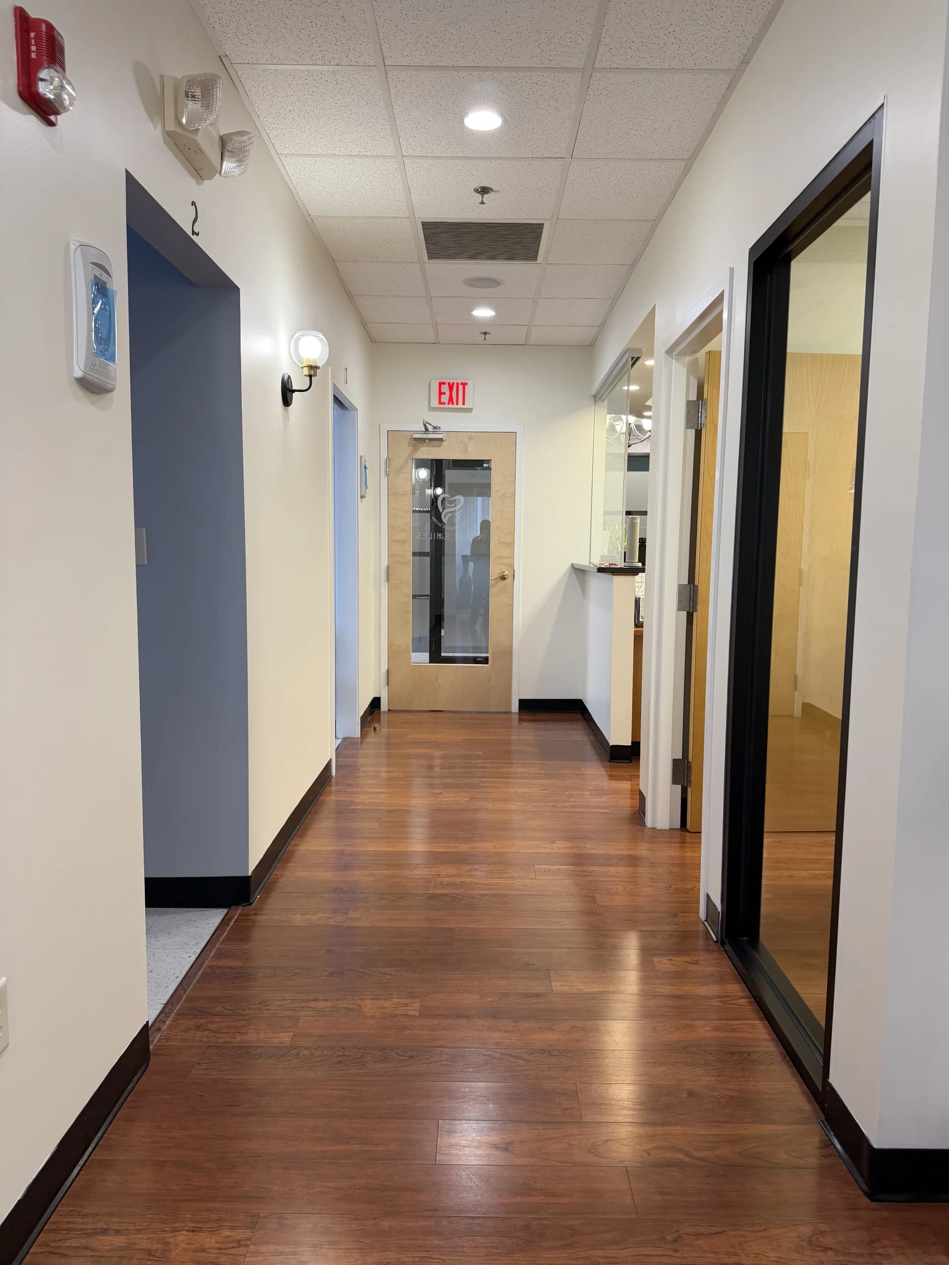 Clean, modern clinical hallway leading to treatment rooms at Innova Smiles, Marlborough MA